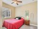 Inviting bedroom featuring light walls, wood-look floors, ceiling fan and a window at 20520 E Mockingbird Dr, Queen Creek, AZ 85142