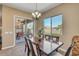 Elegant dining area with a chandelier, view to the outside patio, and room for Gathering gatherings at 20520 E Mockingbird Dr, Queen Creek, AZ 85142