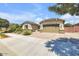 A well-maintained home with a two-car garage and desert landscaping, with a brick paver driveway at 20520 E Mockingbird Dr, Queen Creek, AZ 85142