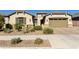 Charming single-story home with a desert landscape, a paver driveway, and a two-car garage at 20520 E Mockingbird Dr, Queen Creek, AZ 85142