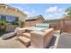 Inviting hot tub surrounded by mature landscaping, pavers and block fencing at 20520 E Mockingbird Dr, Queen Creek, AZ 85142