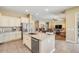 Spacious kitchen features an island with a sink and a breakfast bar, connecting to the living area at 20520 E Mockingbird Dr, Queen Creek, AZ 85142