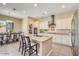 A well-designed kitchen offers white cabinetry, stainless appliances, and a functional island with bar stool seating at 20520 E Mockingbird Dr, Queen Creek, AZ 85142