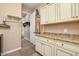 Well-organized laundry room with upper cabinets, storage space, and convenient access to other areas of the home at 20520 E Mockingbird Dr, Queen Creek, AZ 85142