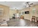 Open living space featuring a ceiling fan, light-colored walls, wood floors and exercise equipment at 20520 E Mockingbird Dr, Queen Creek, AZ 85142