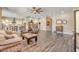 A large living space flows to the kitchen, featuring wood flooring and neutral color scheme at 20520 E Mockingbird Dr, Queen Creek, AZ 85142