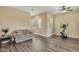 Bright living space with neutral walls, wood floors, comfortable seating and exercise bike at 20520 E Mockingbird Dr, Queen Creek, AZ 85142