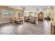 Spacious open-concept living area with wood floors seamlessly connecting to the kitchen and dining areas at 20520 E Mockingbird Dr, Queen Creek, AZ 85142