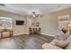 Spacious living room filled with natural light, wood floors, neutral colors and ceiling fan at 20520 E Mockingbird Dr, Queen Creek, AZ 85142
