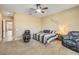 Cozy main bedroom with a ceiling fan, plush carpet, and space for seating, perfect for relaxation at 20520 E Mockingbird Dr, Queen Creek, AZ 85142