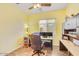 Bright and functional home office with a ceiling fan and built-in storage solutions at 20520 E Mockingbird Dr, Queen Creek, AZ 85142