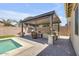 Outdoor kitchen and bar area, perfect for entertaining poolside and enjoying the outdoors at 20520 E Mockingbird Dr, Queen Creek, AZ 85142