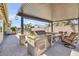 Outdoor kitchen featuring built-in grill, counter space, and seating under a covered patio at 20520 E Mockingbird Dr, Queen Creek, AZ 85142