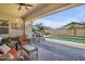 Inviting covered patio with comfortable seating overlooking a refreshing pool and landscaped backyard at 20520 E Mockingbird Dr, Queen Creek, AZ 85142