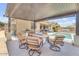 Outdoor patio featuring a built-in grill, counter space, a fire pit, and a refreshing pool at 20520 E Mockingbird Dr, Queen Creek, AZ 85142