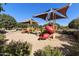 Community playground featuring covered play structures and bright red slides surrounded by well-maintained landscaping at 20520 E Mockingbird Dr, Queen Creek, AZ 85142