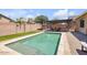Inviting backyard pool with patio, pergola, and lush landscaping creates an ideal outdoor living space at 20520 E Mockingbird Dr, Queen Creek, AZ 85142