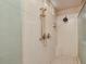 Modern shower with a handheld shower head, built-in seat, and sleek design at 20520 E Mockingbird Dr, Queen Creek, AZ 85142