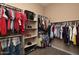 Organized walk-in closet featuring custom shelving, ample storage and a safe for valuables at 20520 E Mockingbird Dr, Queen Creek, AZ 85142
