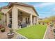 Expansive backyard featuring an extended covered patio and low maintenance artificial turf at 20652 W Clearstream Dr, Buckeye, AZ 85396