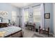 Bedroom with blue walls, carpet flooring, coordinated decor and two windows at 20652 W Clearstream Dr, Buckeye, AZ 85396