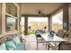 Relaxing covered patio with ample seating, ceiling fan, and views of the serene backyard at 20652 W Clearstream Dr, Buckeye, AZ 85396