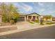 Charming home with a two-car garage, well-maintained landscaping, and a welcoming front porch at 20652 W Clearstream Dr, Buckeye, AZ 85396