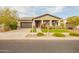Charming home with a two-car garage, well-maintained landscaping, and a welcoming front porch at 20652 W Clearstream Dr, Buckeye, AZ 85396
