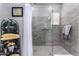 Shower featuring gray tile and glass door at 20652 W Clearstream Dr, Buckeye, AZ 85396