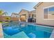 Inviting backyard featuring a sparkling pool, covered patio, and lush landscaping, ideal for relaxation and outdoor living at 21090 E Camina Buena Vis, Queen Creek, AZ 85142