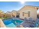 Beautiful backyard featuring a sparkling pool, cozy seating areas, and lush landscaping, perfect for outdoor entertaining at 21090 E Camina Buena Vis, Queen Creek, AZ 85142