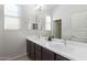 Bathroom with a large mirror, double sinks, and bright, natural light at 21090 E Camina Buena Vis, Queen Creek, AZ 85142