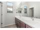 Bathroom featuring dual sinks, framed mirror, and wood-look flooring at 21090 E Camina Buena Vis, Queen Creek, AZ 85142