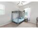 Bedroom featuring a bunk bed, a window, a ceiling fan, and a bedside table at 21090 E Camina Buena Vis, Queen Creek, AZ 85142