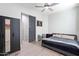 This is a bedroom with natural light, gray walls, a ceiling fan, and a closet at 21090 E Camina Buena Vis, Queen Creek, AZ 85142