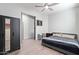 This is a bedroom with natural light, gray walls, a ceiling fan, and a closet at 21090 E Camina Buena Vis, Queen Creek, AZ 85142