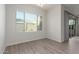 Bright dining room features wood-look tile, modern lighting, and a large window at 21090 E Camina Buena Vis, Queen Creek, AZ 85142