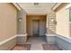Inviting entryway with decorative door, neutral paint, and covered porch leading to the front door at 21090 E Camina Buena Vis, Queen Creek, AZ 85142