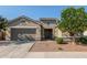 Charming single-story home featuring a two-car garage, landscaped yard, and welcoming front entrance at 21090 E Camina Buena Vis, Queen Creek, AZ 85142