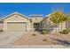 Charming single-story home features a well-maintained front yard with desert landscaping and a two-car garage at 21090 E Camina Buena Vis, Queen Creek, AZ 85142