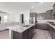 Spacious kitchen featuring a large center island, granite countertops, and stainless steel appliances at 21090 E Camina Buena Vis, Queen Creek, AZ 85142