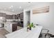 Modern kitchen with stainless steel appliances, dark cabinets, granite countertops, and an island at 21090 E Camina Buena Vis, Queen Creek, AZ 85142
