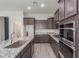 Well-equipped kitchen featuring a large island, granite countertops, and stainless steel appliances at 21090 E Camina Buena Vis, Queen Creek, AZ 85142