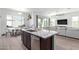 Open-concept kitchen with center island, stainless appliances, and adjoining dining and living areas at 21090 E Camina Buena Vis, Queen Creek, AZ 85142