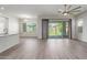 Open living room with tile floors, ceiling fan, and sliding glass doors leading to a backyard at 21090 E Camina Buena Vis, Queen Creek, AZ 85142