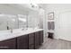 Main bathroom with double sink vanity, a large mirror, and a glass shower enclosure at 21090 E Camina Buena Vis, Queen Creek, AZ 85142