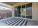 Covered patio features sleek glass doors offering seamless transition to outdoor living and entertainment at 21090 E Camina Buena Vis, Queen Creek, AZ 85142
