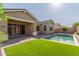 Backyard view showcasing private pool, patio area, and lush landscaping at 21090 E Camina Buena Vis, Queen Creek, AZ 85142