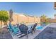 Relaxing pool area surrounded by stylish seating, lush greenery, and a well-maintained backyard with nice view at 21090 E Camina Buena Vis, Queen Creek, AZ 85142