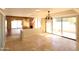 Open concept dining area with travertine tile flooring, chandelier and slider door at 219 W Denton Ln, Phoenix, AZ 85013